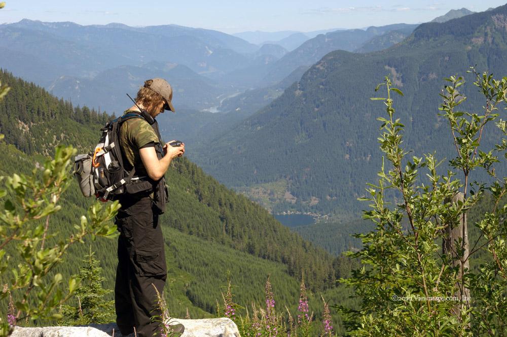 Geoff checking his GPS, Lake Kawkawa peaking out in the distance