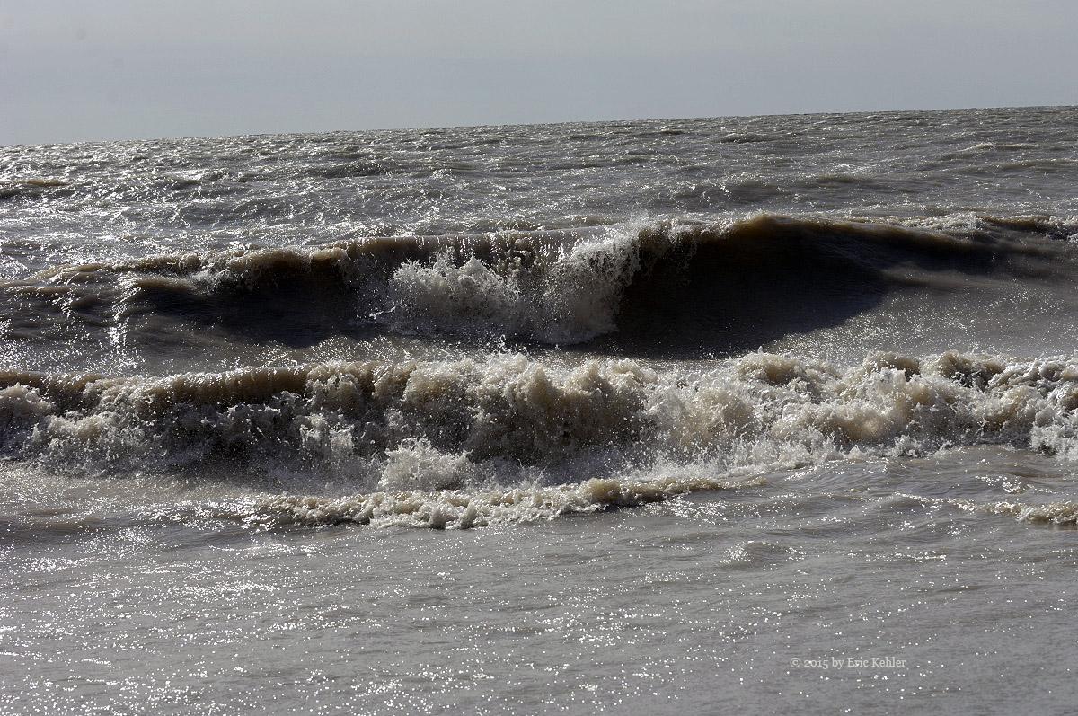 Looking out at the high waves from the base of the cliff