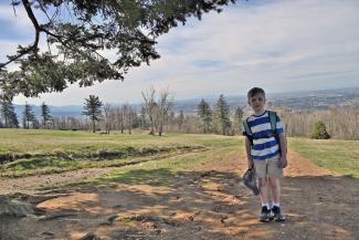 Elijah on McKee Peak, Abbotsford and Vancouver in the distance