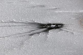 This frozen over hole looks quite other worldly.