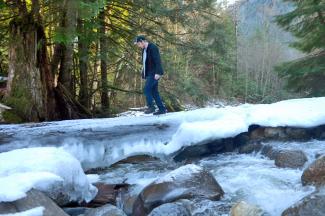Geoff crossing the creek on what remains of the old brisge