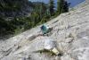 Carolyn scrambling up a steep rock face